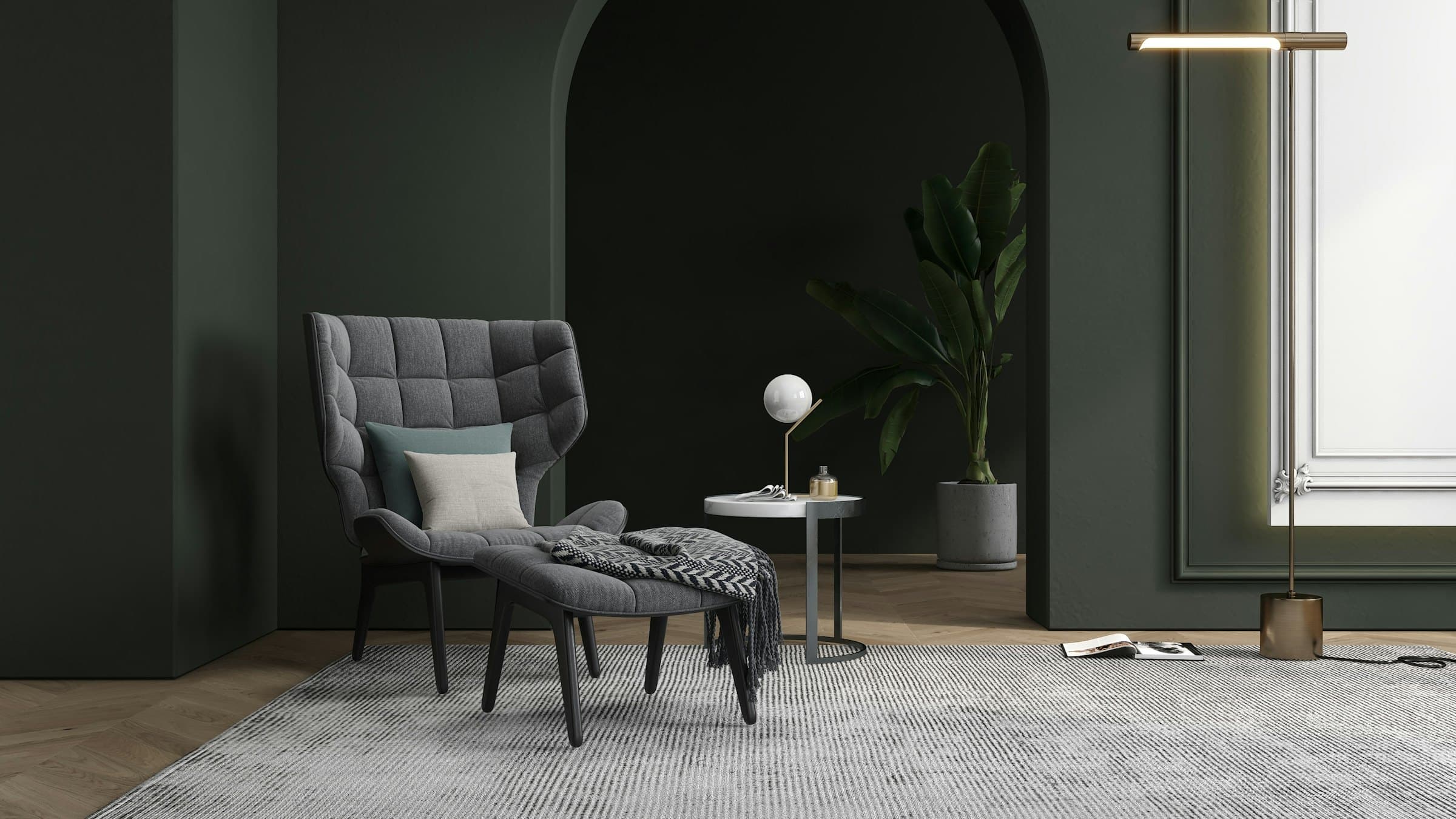 Moody gray-green room with an arched alcove, a gray quilted lounge chair and ottoman on a pale rug, and a slim brass wall light beside a bright tall window